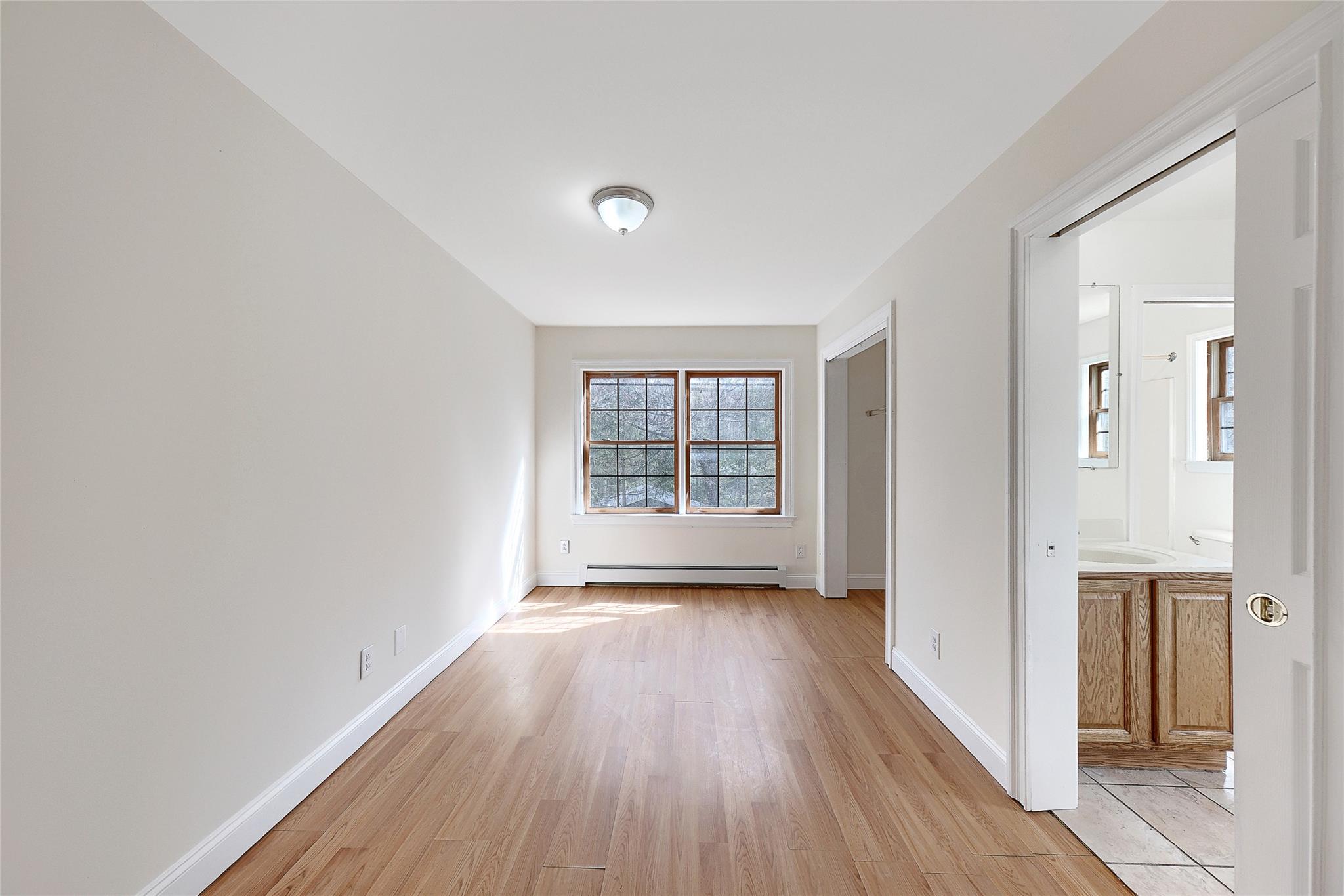 115 E Road Wurtsboro, NY 12790 - Photo 16 of 33 a view of an empty room with wooden floor and a window