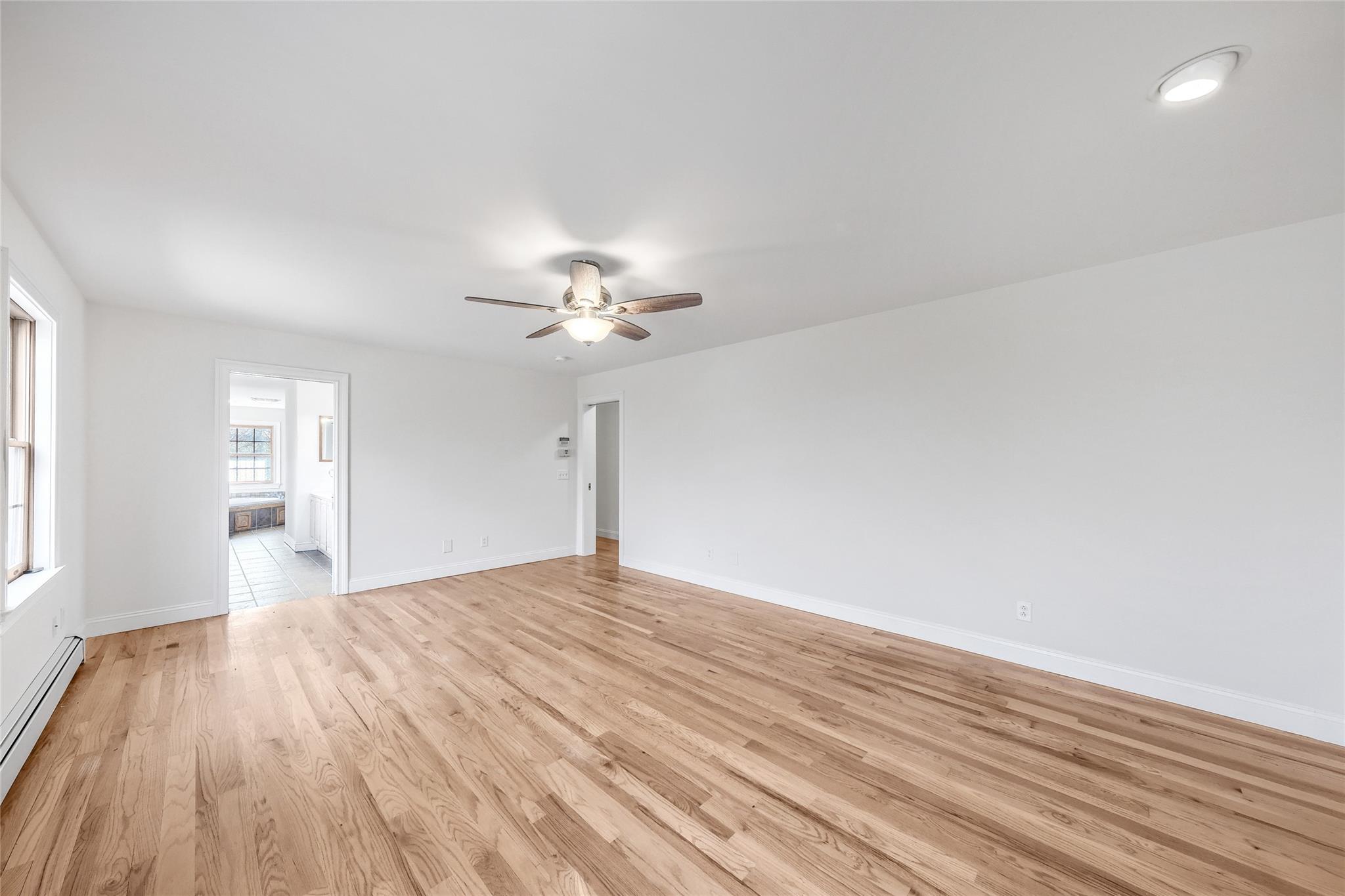 115 E Road Wurtsboro, NY 12790 - Photo 23 of 33 a view of empty room with wooden floor and fan