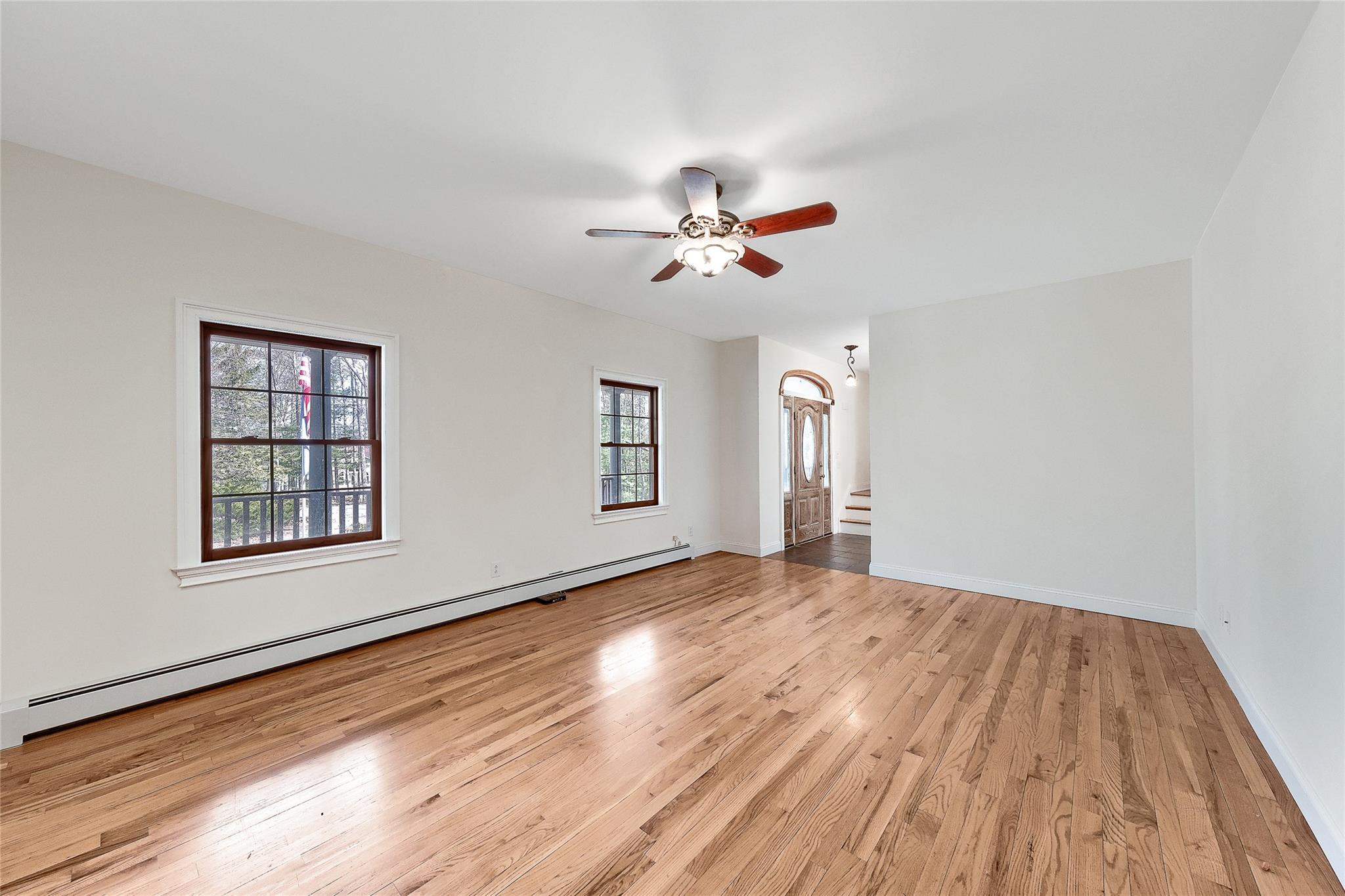 115 E Road Wurtsboro, NY 12790 - Photo 4 of 33 a view of an empty room with a window and wooden floor