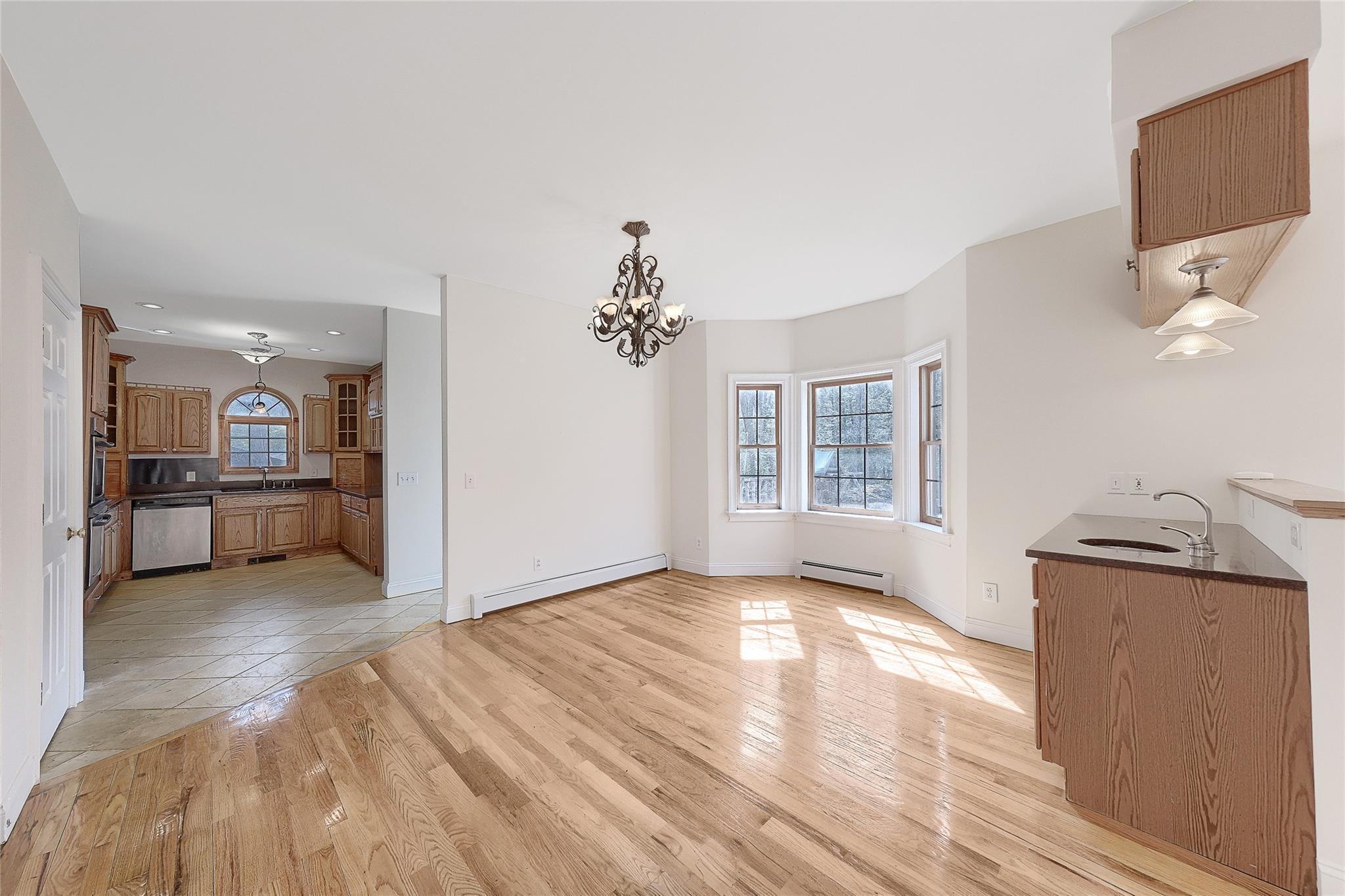 115 E Road Wurtsboro, NY 12790 - Photo 7 of 33 a view of a big room with wooden floor and a kitchen