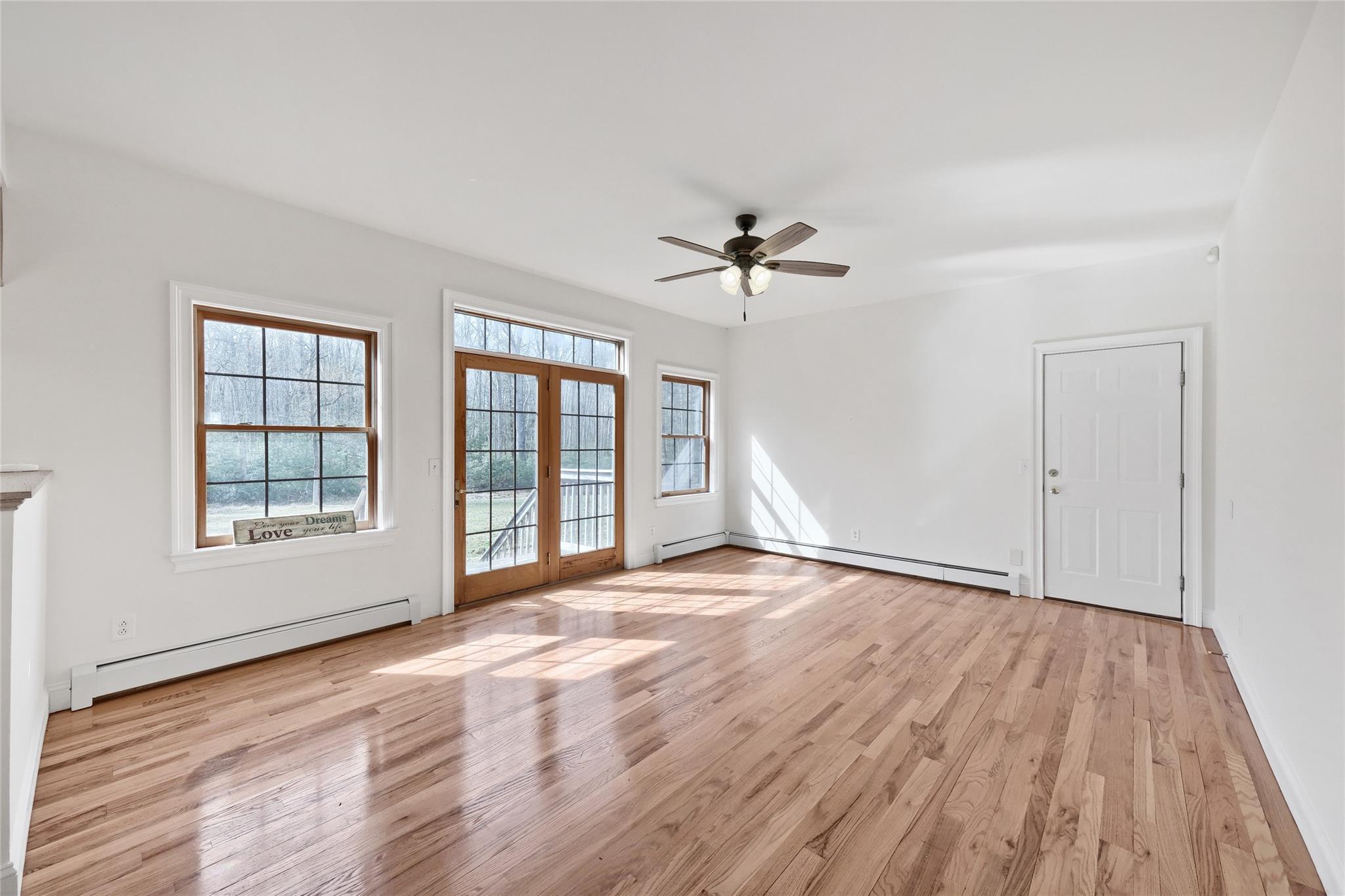115 E Road Wurtsboro, NY 12790 - Photo 8 of 33 a view of an empty room with a window and wooden floor