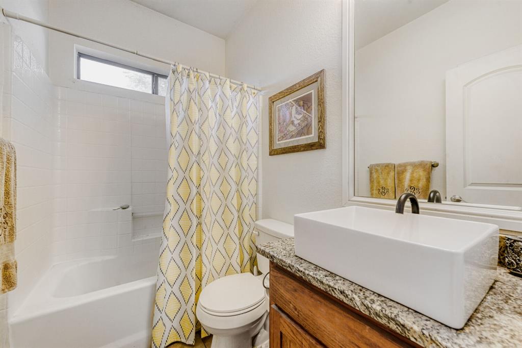 6525 Greenway Road Fort Worth, TX 76116 - Photo 14 of 29 a bathroom with a sink toilet and shower