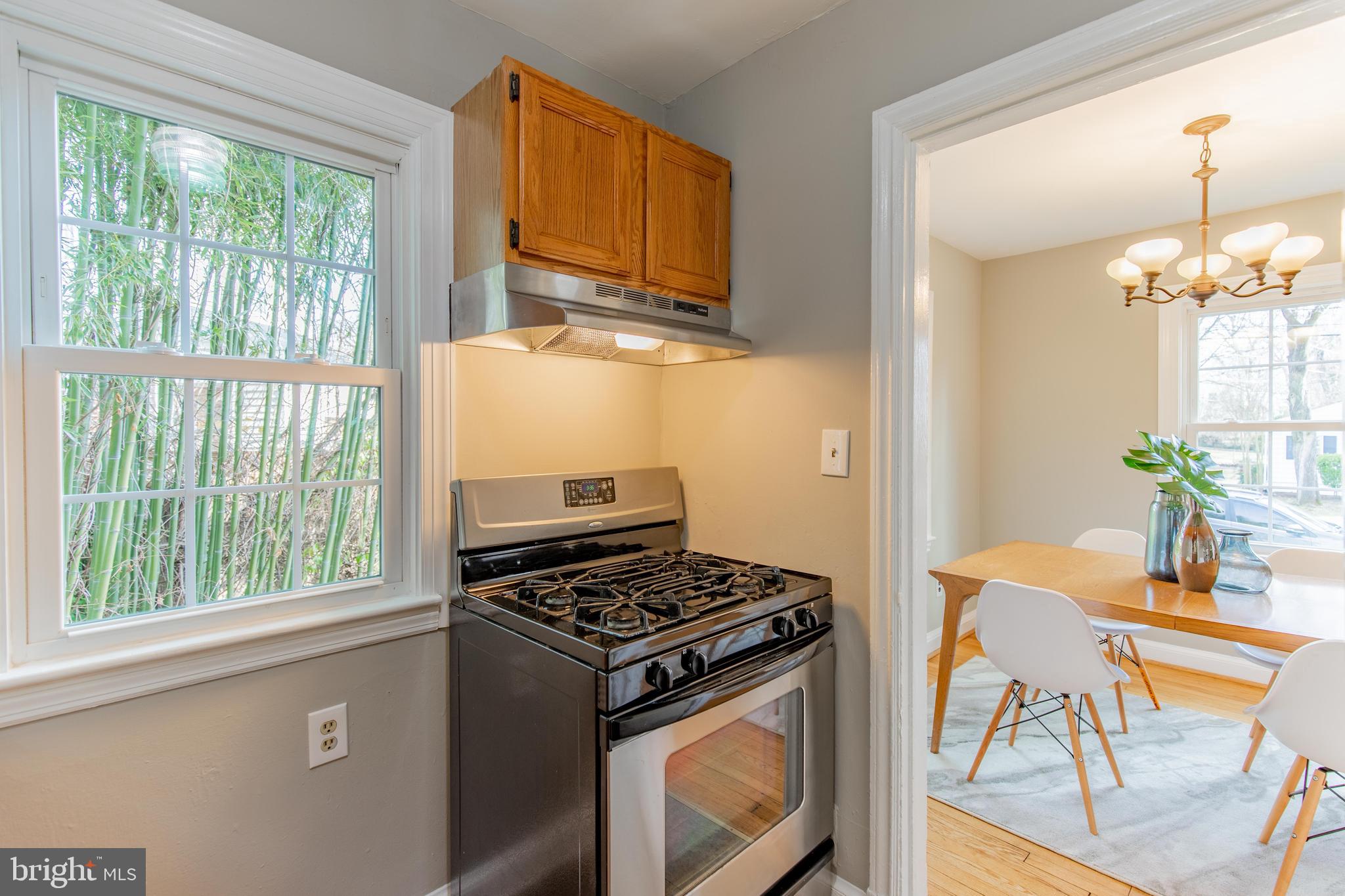 502 East Schuyler Road Silver Spring, MD 20901 - Photo 13 of 29 a kitchen that has a stove and a table chair