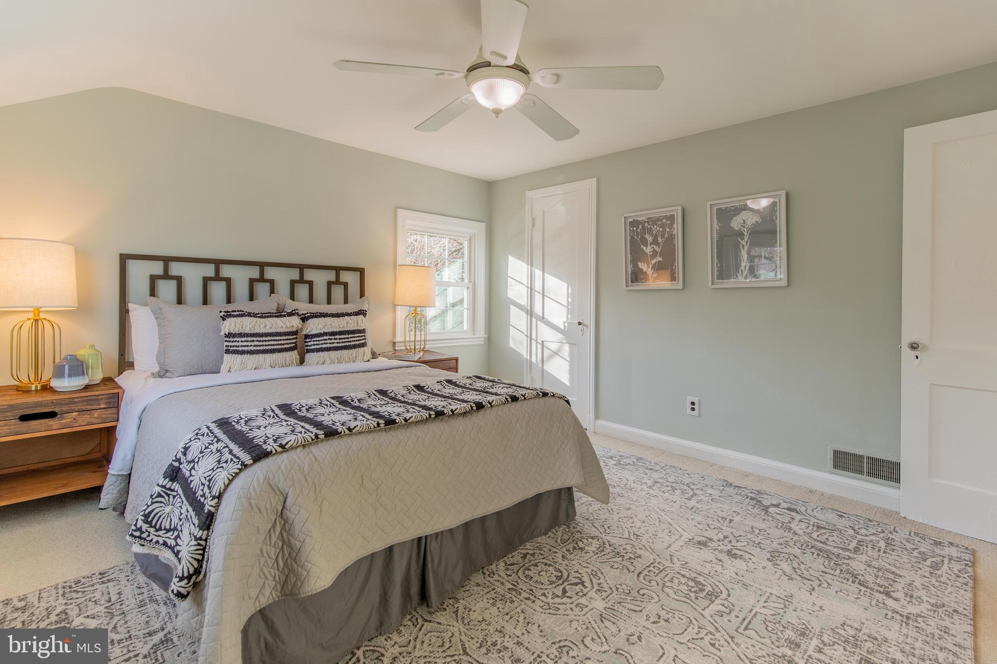 502 East Schuyler Road Silver Spring, MD 20901 - Photo 15 of 29 a bedroom with a large bed and a chandelier