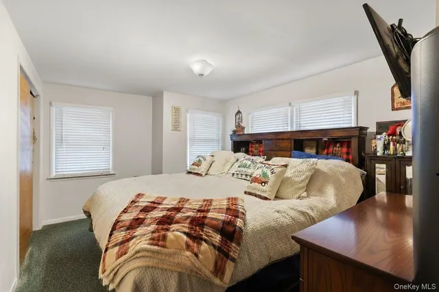 a bed sitting in a bedroom next to a window