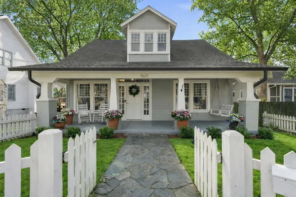 a front view of a house with fountain and porch