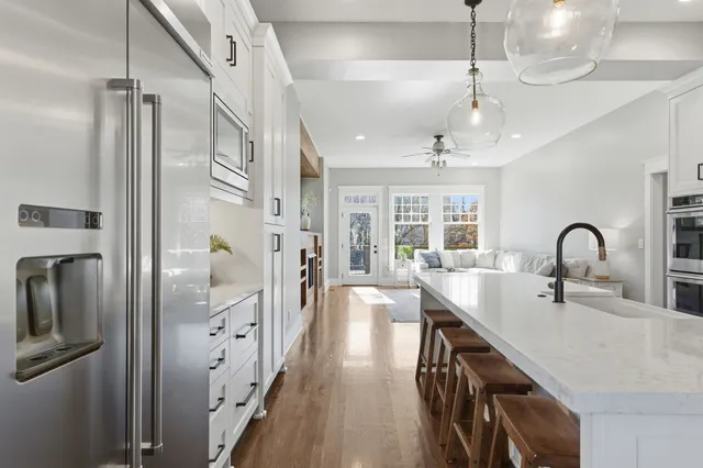 a spacious bathroom with a double vanity sink a mirror and a shower