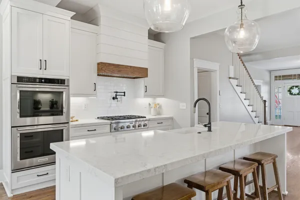 a kitchen with stainless steel appliances a stove a sink a microwave and cabinets