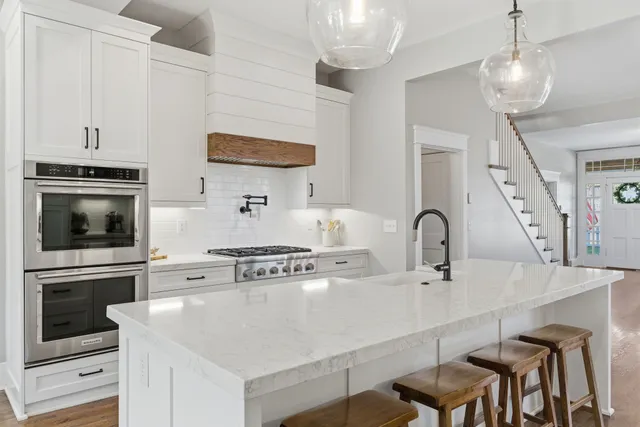 a kitchen with stainless steel appliances a stove a sink a microwave and cabinets