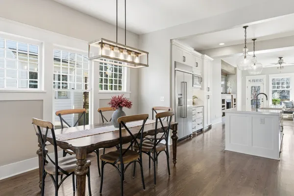 a view of a dining room with furniture and chandelier