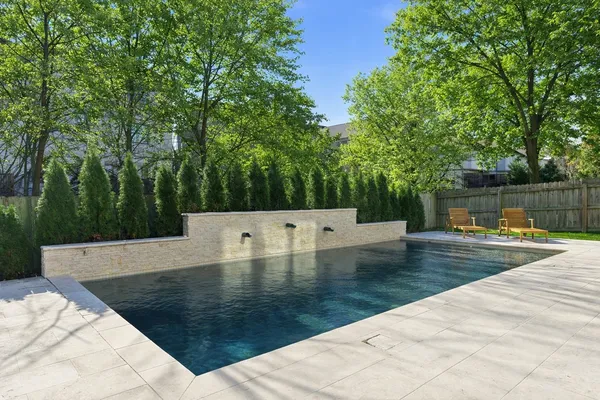 swimming pool view with a sitting space