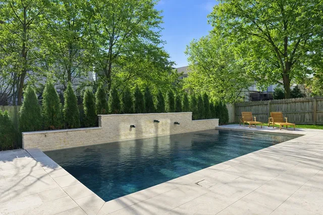 swimming pool view with a sitting space