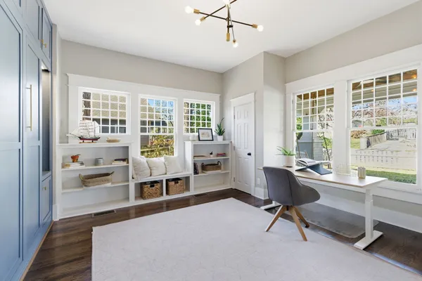 a living room with furniture a large window and table