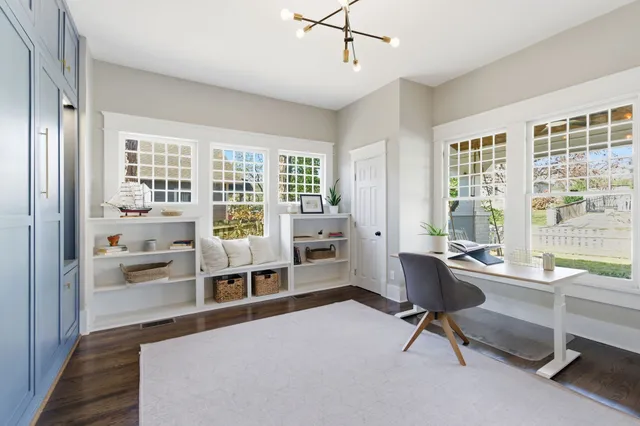 a living room with furniture a large window and table