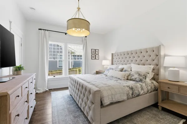 a bedroom with a bed and a chandelier