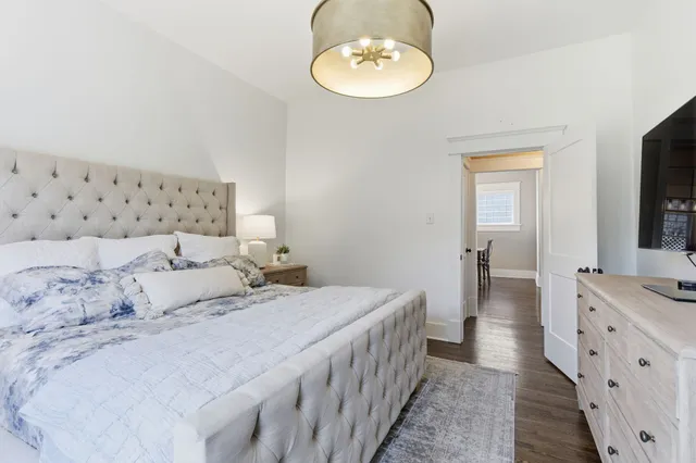 a bedroom with a bed and a chandelier