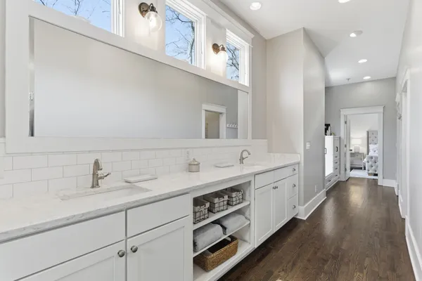 a spacious bathroom with a double vanity sink and a mirror