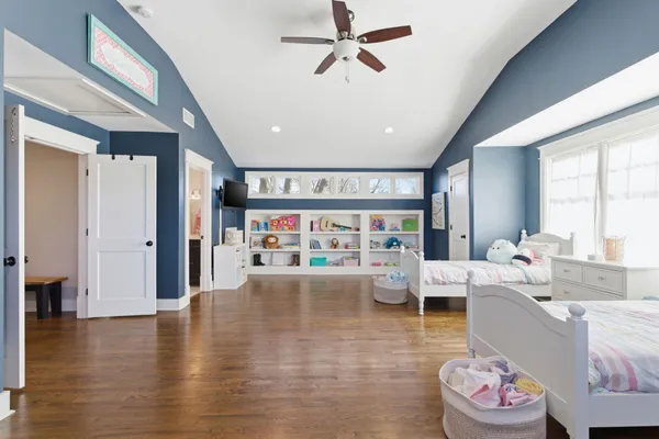 a living room with furniture and a book shelf