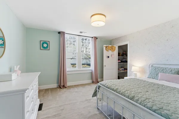 a bedroom with a bed and a table in it