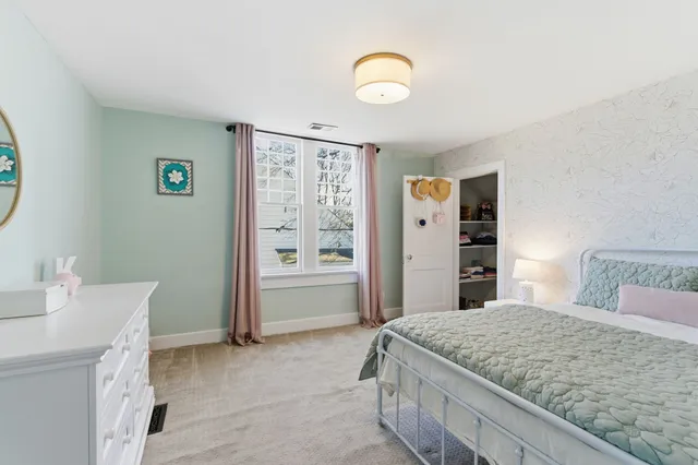 a bedroom with a bed and a table in it