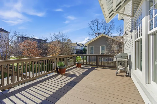 a view of a house with a wooden deck
