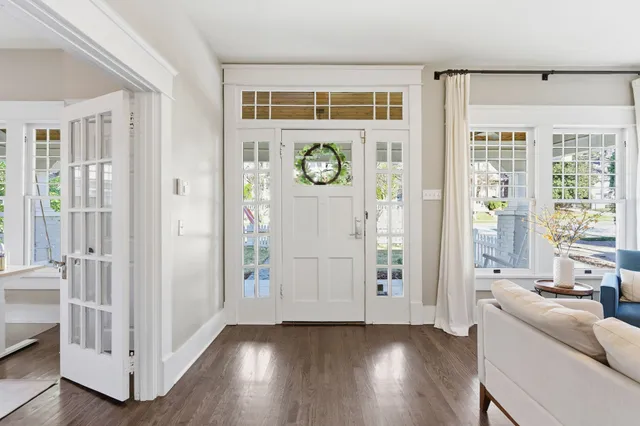a view of an entryway with wooden floor