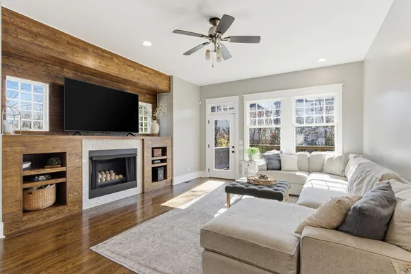 a living room with fireplace furniture and a flat screen tv