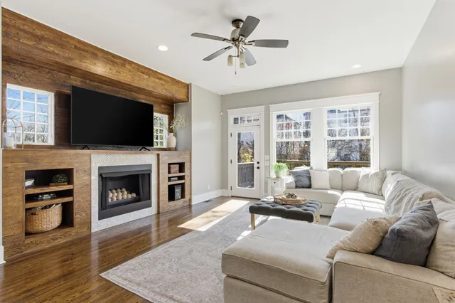 a living room with fireplace furniture and a flat screen tv