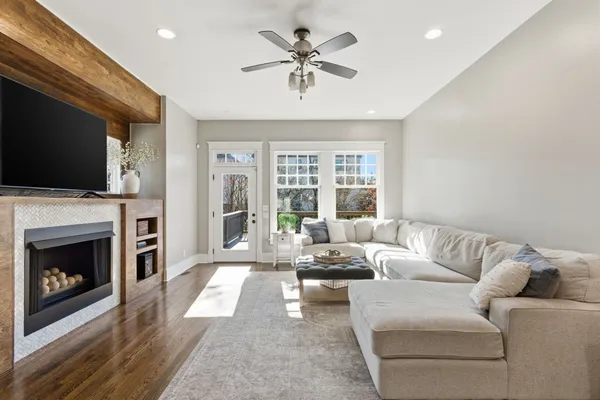 a living room with furniture a fireplace and a flat screen tv
