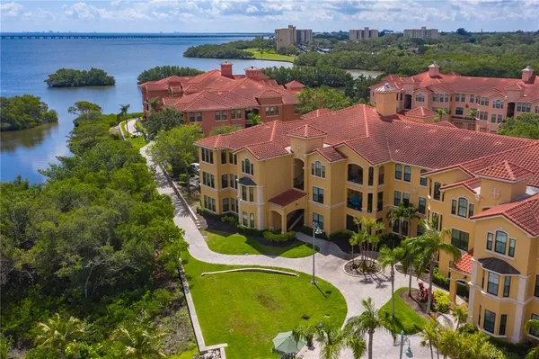 an aerial view of residential houses with outdoor space and swimming pool