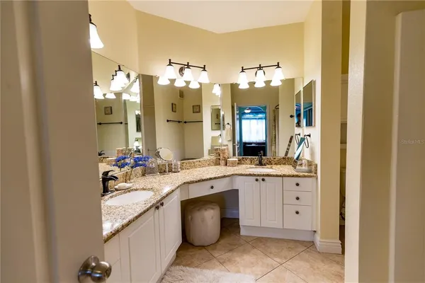 a bathroom with a double vanity sink mirror and