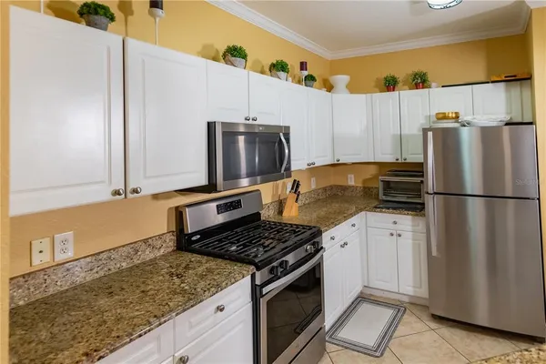 a kitchen with granite countertop cabinets and steel stainless steel appliances