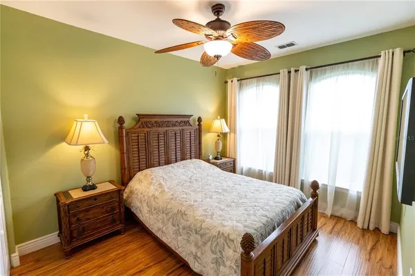 a bedroom with a bed and wooden floor