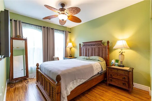 a bedroom with a bed and wooden floor