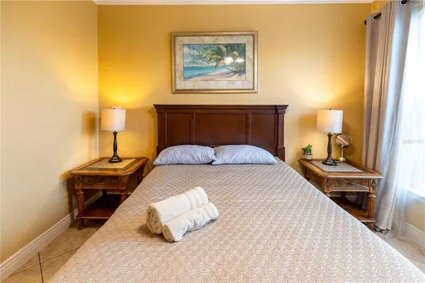 a bedroom with a bed and a chandelier