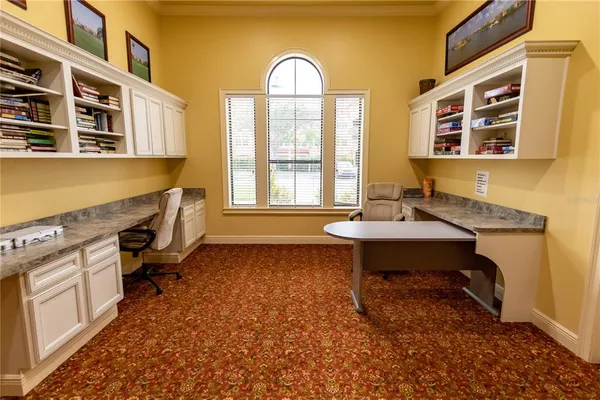 a view of a livingroom with furniture workspace and a window