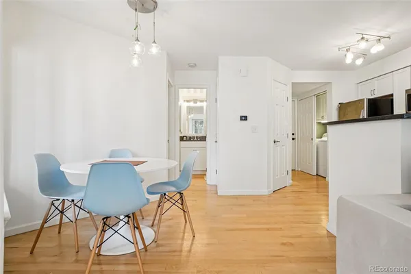 a view of a dining room with furniture and wooden floor