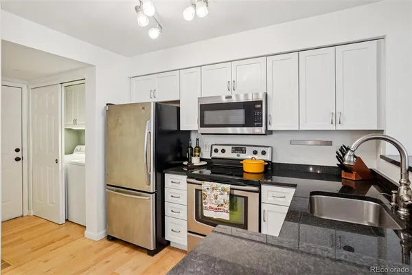 a kitchen with stainless steel appliances granite countertop a stove and a sink