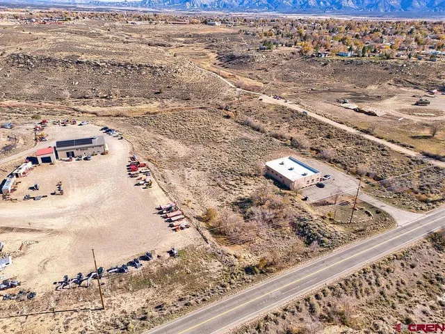 an aerial view of houses with a city view