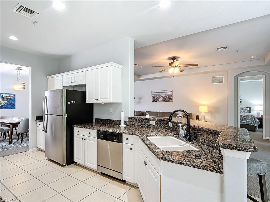 12854 Carrington Circle, Unit 204 Naples, FL 34105 - Photo 11 of 37 a kitchen with a sink stove and refrigerator