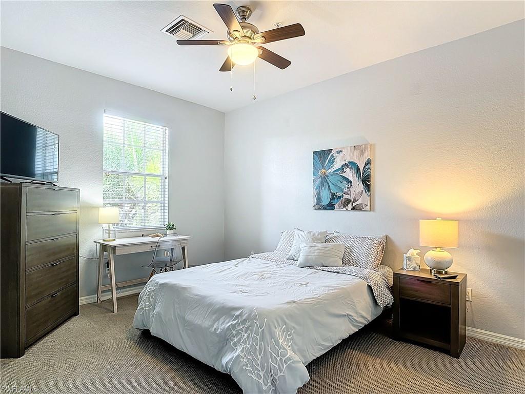 12854 Carrington Circle, Unit 204 Naples, FL 34105 - Photo 16 of 37 a bedroom with a bed and a window