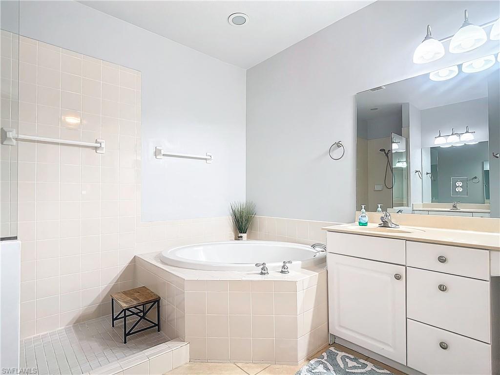 12854 Carrington Circle, Unit 204 Naples, FL 34105 - Photo 21 of 37 a bathroom with a sink vanity and a mirror