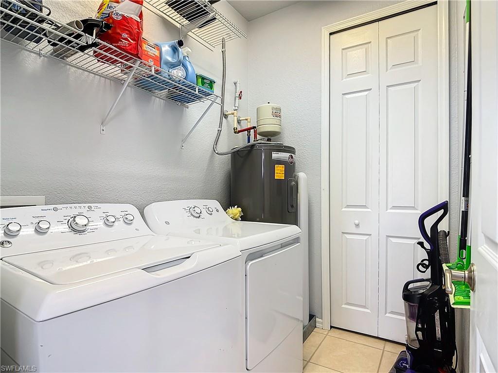 12854 Carrington Circle, Unit 204 Naples, FL 34105 - Photo 23 of 37 a utility room with dryer and washer