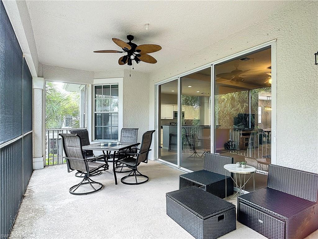 12854 Carrington Circle, Unit 204 Naples, FL 34105 - Photo 26 of 37 a dining room with furniture and large windows