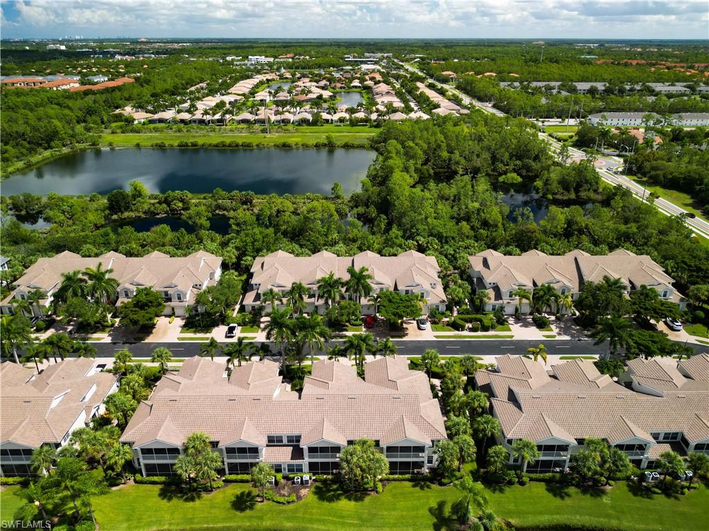 12854 Carrington Circle, Unit 204 Naples, FL 34105 - Photo 28 of 37 an aerial view of residential houses with outdoor space and lake view