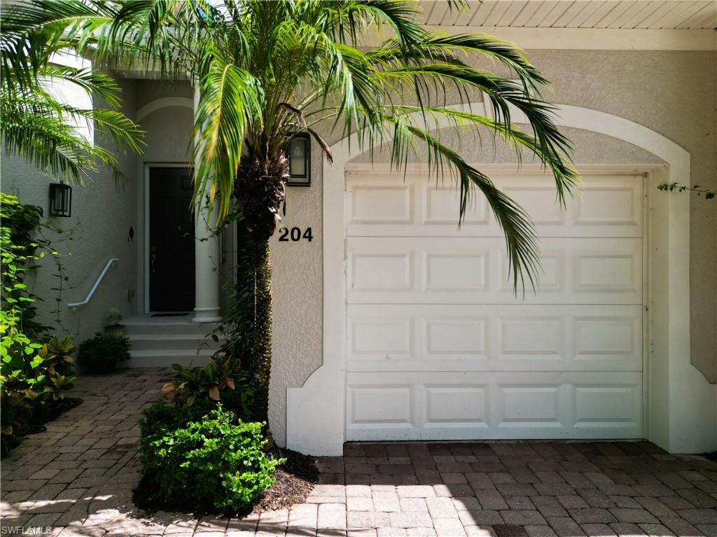 12854 Carrington Circle, Unit 204 Naples, FL 34105 - Photo 32 of 37 a plant that is in front of a house
