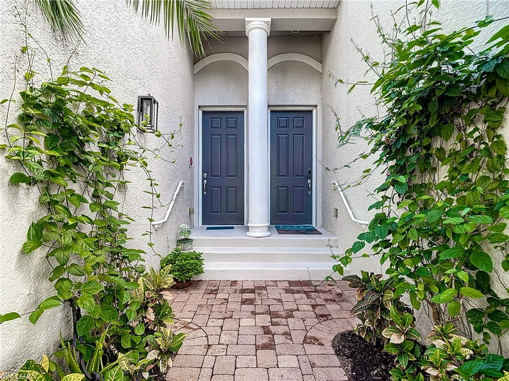 12854 Carrington Circle, Unit 204 Naples, FL 34105 - Photo 33 of 37 a view of entrance of the house and trees