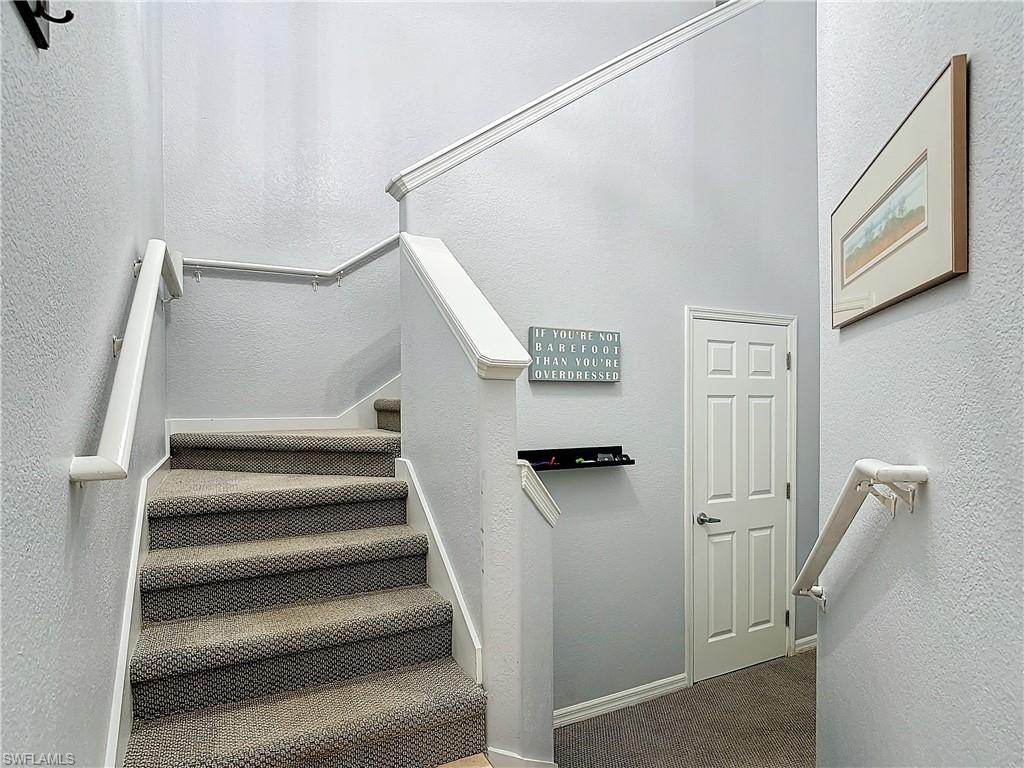 12854 Carrington Circle, Unit 204 Naples, FL 34105 - Photo 35 of 37 a view of staircase with white walls and a window
