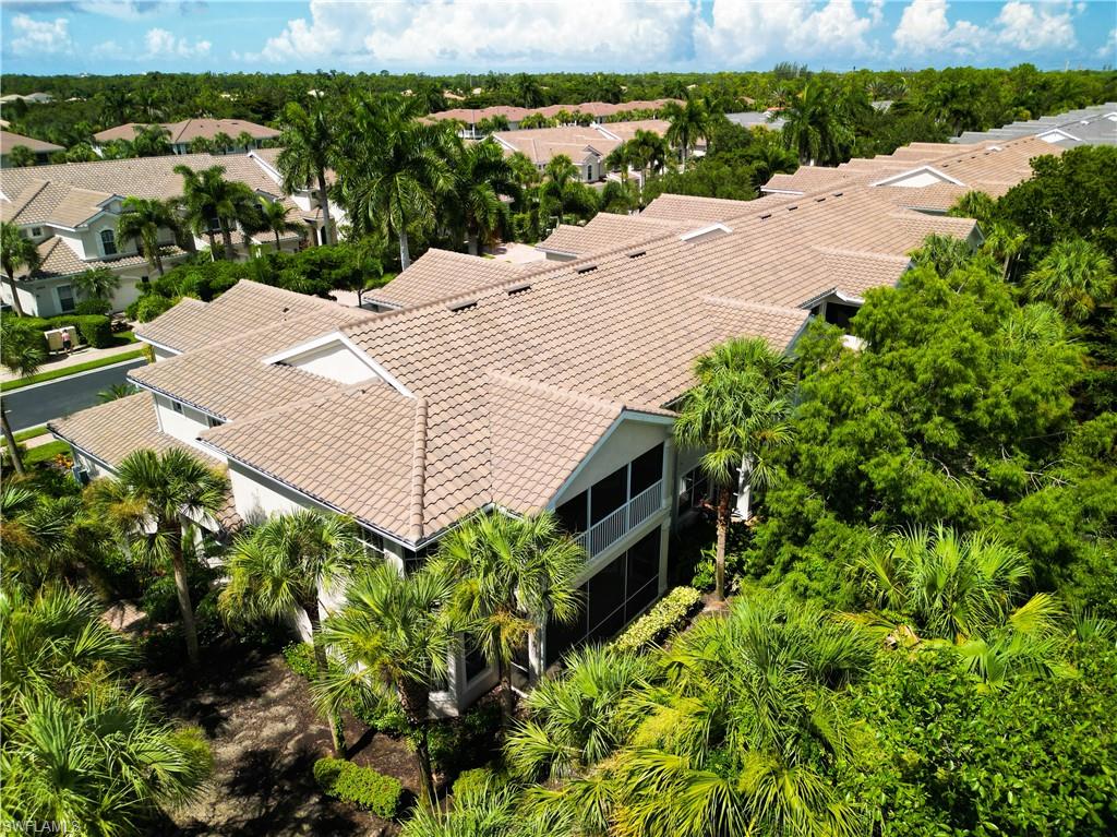 12854 Carrington Circle, Unit 204 Naples, FL 34105 - Photo 36 of 37 an aerial view of a house with a yard and lake view