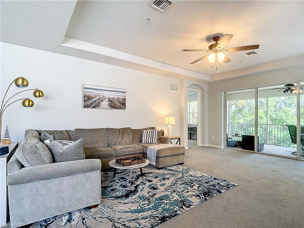 12854 Carrington Circle, Unit 204 Naples, FL 34105 - Photo 7 of 37 a living room with furniture and a large window
